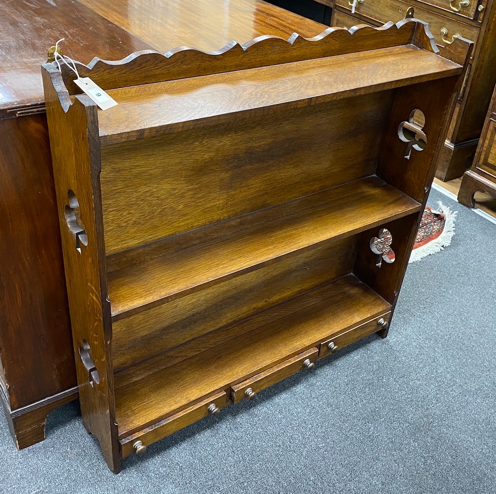 An Edwardian oak two tier wall bracket, width 89cm, depth 17cm, height 92cm